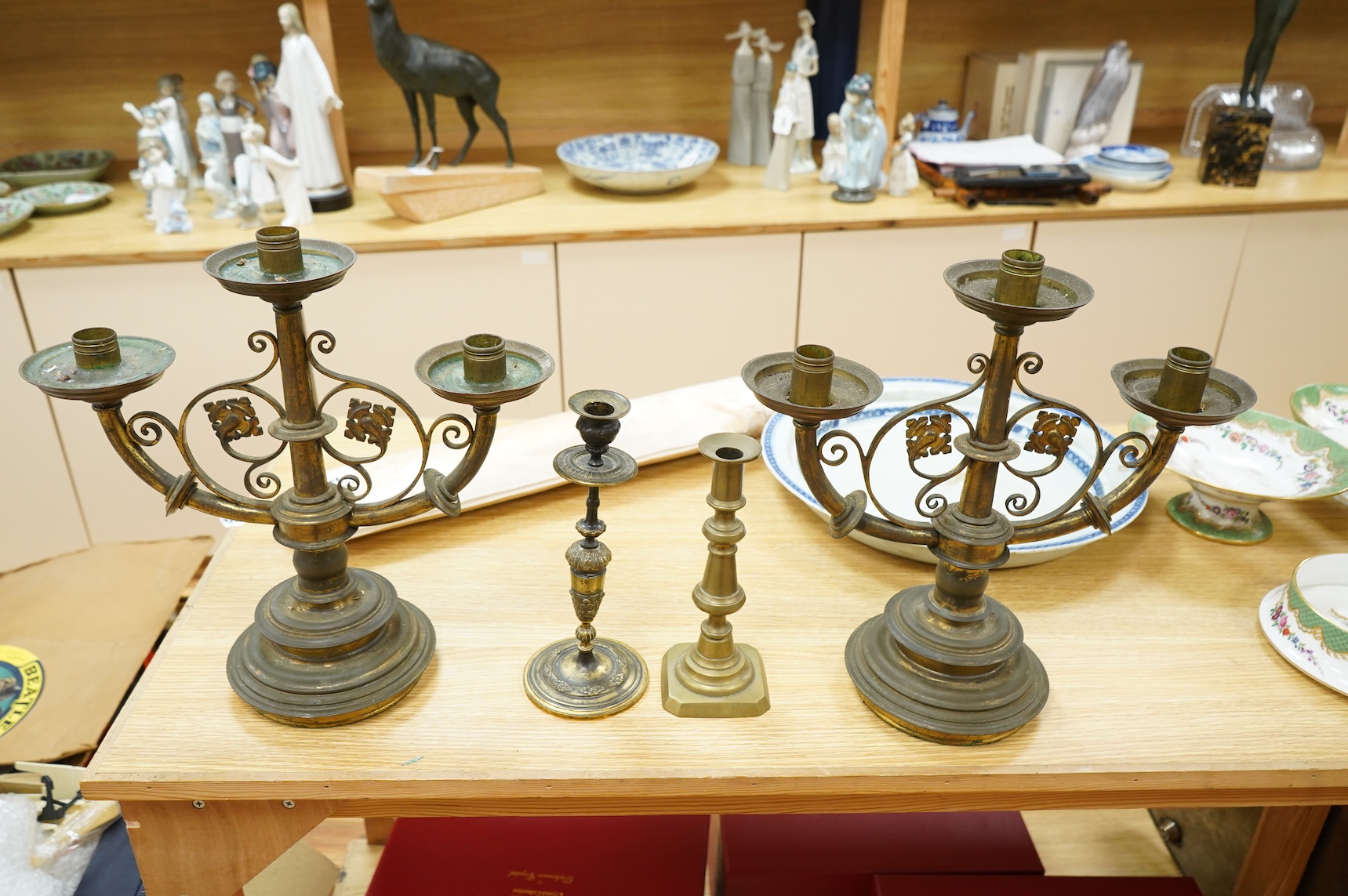 A pair of two brass branch, three light candelabra and two other brass candlesticks, largest 38cm high